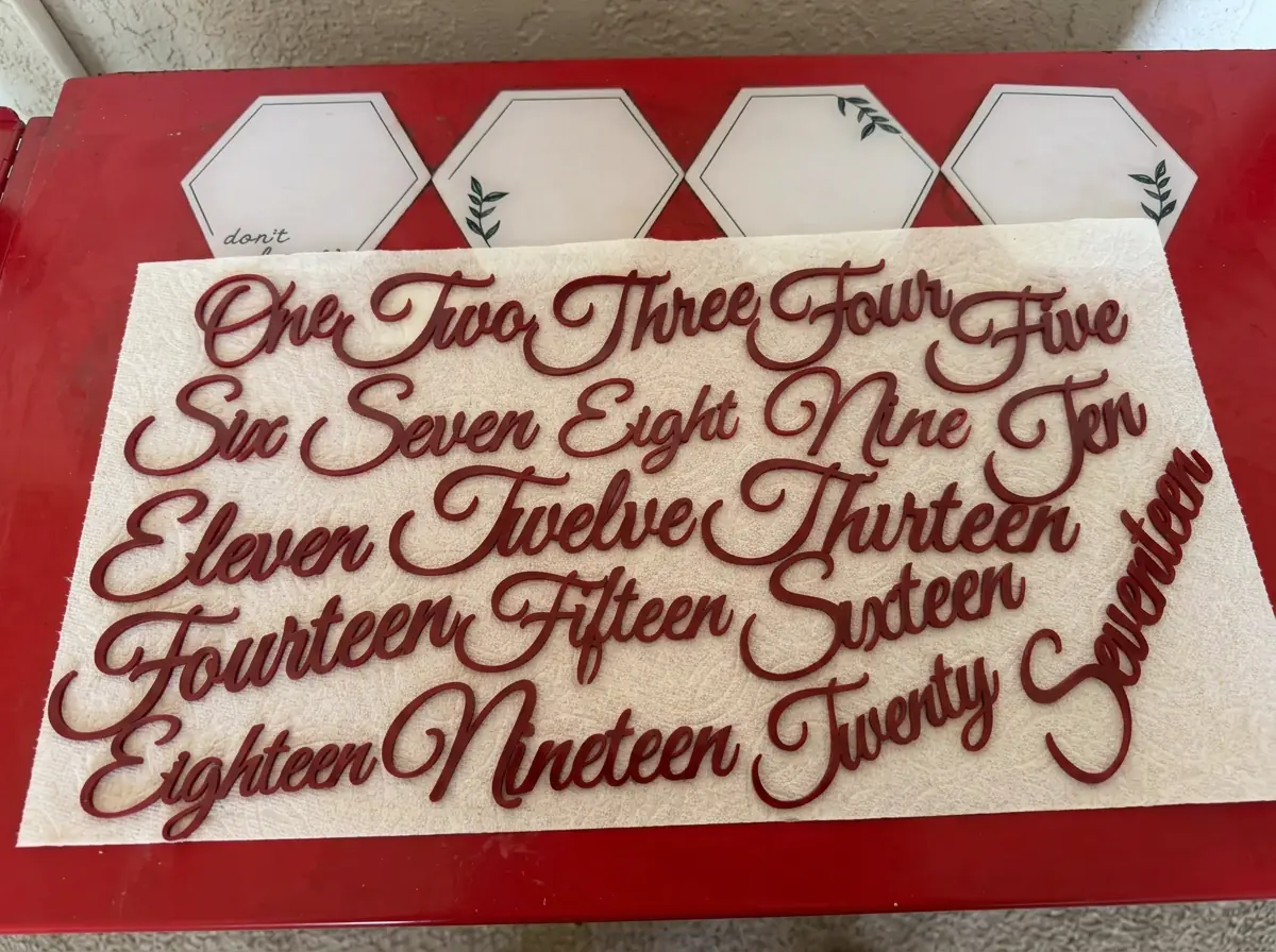 Red laser cut script number words from one through seventeen made with WeldWords